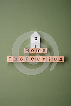 The inscription Home inspection made of wooden cubes on a plain background