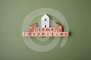 The inscription Home inspection made of wooden cubes on a plain background