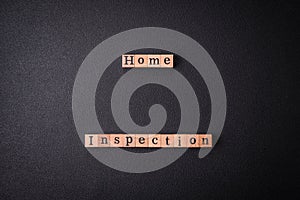 The inscription Home inspection made of wooden cubes on a plain background