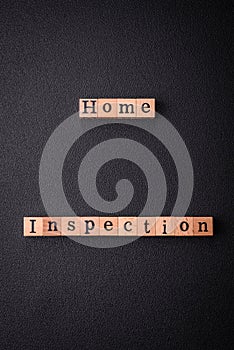 The inscription Home inspection made of wooden cubes on a plain background
