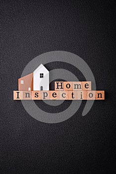 The inscription Home inspection made of wooden cubes on a plain background