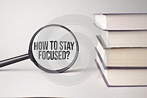 The inscription HOW TO STAY FOCUSED is written and the books. Content lettering is essential for business content and marketing