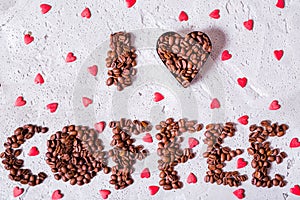 The inscription I love coffee is made of coffee beans on a concrete background
