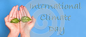 The inscription international climate day on a blue background with hands with a green sprout, background baner