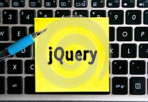 The inscription `jQuery` on a yellow sheet of sticker paper