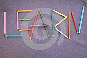 The inscription `learn` is written in colored pencils.