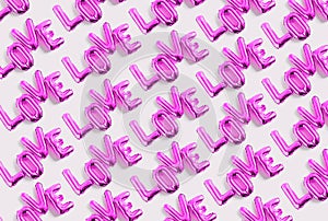 Inscription LOVE foil inflatable purple ballon on the white background. Love, romance and Valentines day background. Flat lay