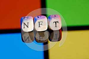 Inscription made of NFT cubes on background of Microsoft company logo