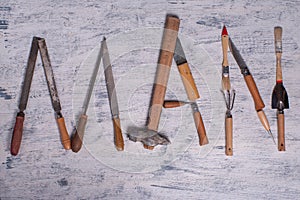 The inscription MAN is written by work tools. The word MAN is made up of a work tools