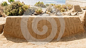 The inscription Maspalomas Gran Canaria carving on sand