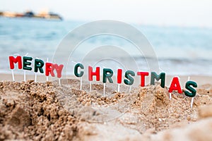 inscription of Merry Christmas on beach. Celebrating Christmas on beach. Vacation at resort in a warm country before New Year