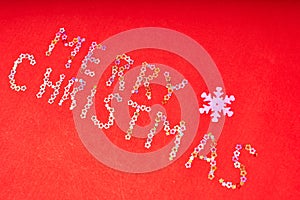 Inscription merry Christmas of decorative stars on a red background