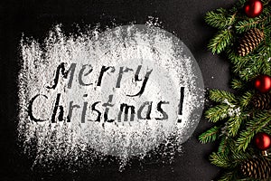 Inscription MERRY CHRISTMAS on powdered sugar background