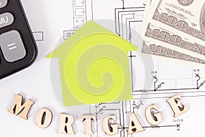 Inscription mortgage, dollar and calculator on electrical drawing, calculations of buying or building house concept