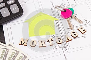 Inscription mortgage, dollar, keys and calculator on electrical drawing, calculations of buying or building house concept