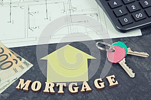Inscription mortgage, euro, keys and calculator on electrical diagrams, calculations of buying house concept