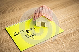 Inscription Mortgage tips in a notebook. Tips for getting a loan to buy a home.