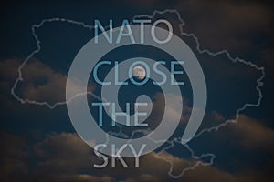 The inscription NATO Close the Sky against the background of the evening sky of Ukraine