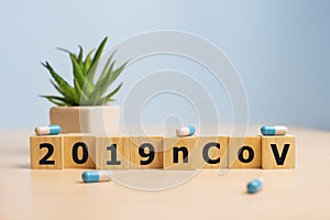 The inscription 2019nCoV on wooden cubes, blue background. Health concept, Chinese 2019 virus-ncov. photo