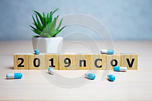 The inscription 2019nCoV on wooden cubes, blue background. Health concept, Chinese 2019 virus-ncov photo