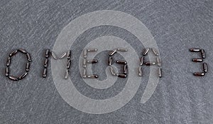 Inscription Omega 3 on black background Gel capsules