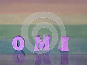 Inscription omi on background of lgbt flag made of wood