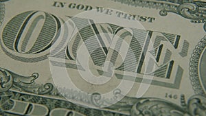 The inscription `ONE` on a one-dollar bill