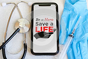 Inscription on the phone Be a Hero - Save a Life Today
