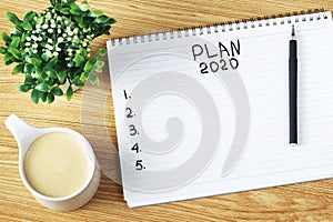 Inscription Plan 2020 in notepad, close-up, top view, concept of planning, goal setting