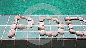 The inscription pool is laid out by pebble on a pool side