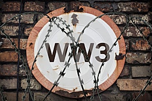 The inscription on the round rusty sign of the Third World War. War Risk Warning