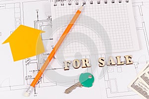 Inscription for sale, key, notepad and money on electrical diagrams, selling and buying house or flat concept