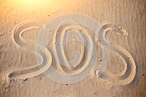 The inscription on the sand beach SOS