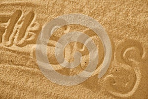 Inscription on the sand beach SOS with hashtag. Space for text