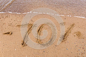 Inscription on the sand minus 70 %, discounts