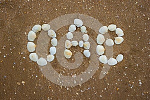 Inscription on sand from shells - uae, oae, camping, tourism