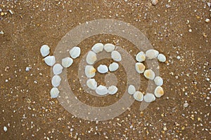 Inscription on sand from shells - yes, camping, tourism