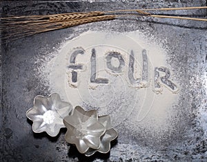 Inscription on sprinkle flour on black background