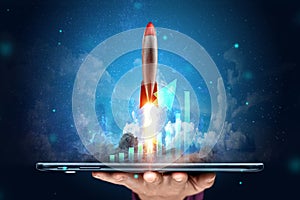 The inscription start-up, the rocket taking off on the background image of the development strategy charts, business concept, new