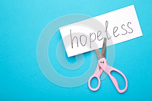 The inscription on the sticker: HOPELESS cut in half on an blue background