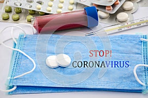 The inscription `stop coronavirus`. Coronavirus 2019-nCoV concept. Protective breathing mask and medication. New Chinese coronavir