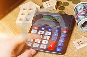 Inscription Tax on the calculator. The concept of paying taxes for the property. Liabilities or repayment of tax debt. Calculated photo
