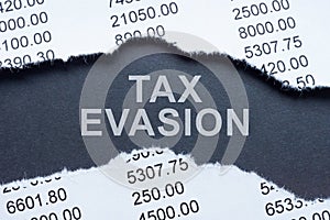 Inscription tax evasion and torn financial report. photo