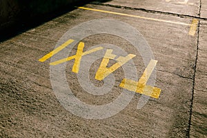 Inscription TAXI on the tarmac. Parking space for taxis.