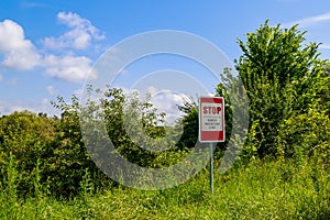 The inscription or text in English STOP BORDER PROTECTION STRIP. Warning post about the state border. Background