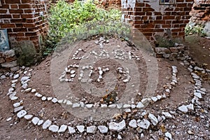 The inscription Thank God, laid out on the sand from fragments of stones