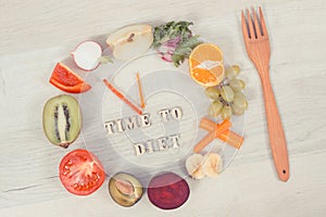 Inscription time to diet and nutritious fruits and vegetables in shape of clock, healthy lifestyle concept