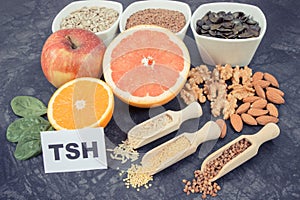 Inscription TSH with nutritious products and ingredients containing vitamins for healthy thyroid photo