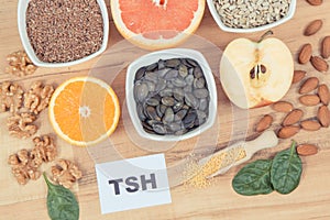 Inscription TSH with Products and ingredients containing vitamins for healthy thyroid