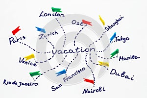 The inscription `vacation` and names of cities marked with pins. Concept of travel planning